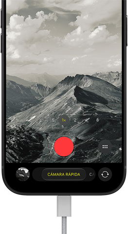 iPhone 18 Pro, parte frontal, se muestra un paisaje montañoso, con la interfaz de la app Cámara superpuesta en modo de cámara rápida, con el cable de corriente conectado al puerto de carga
